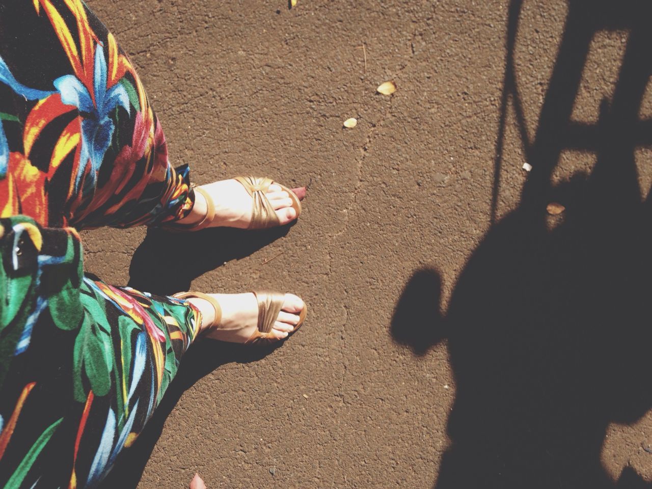 low section, lifestyles, men, street, person, leisure activity, high angle view, shoe, standing, shadow, unrecognizable person, sunlight, road, outdoors, human foot, day