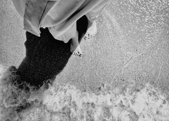 Low section of a girl standing on beach