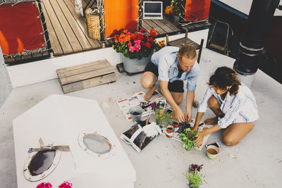 High angle view of couple planting in houseboat