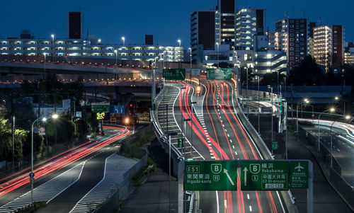 Light trails on city street at dusk