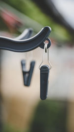 Close-up of electric lamp hanging on metal