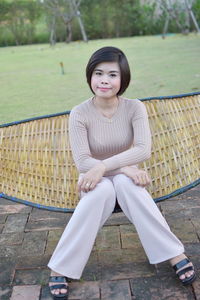 Portrait of woman sitting on bench