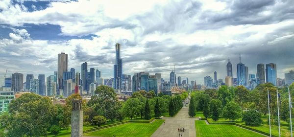 Panoramic view of city against cloudy sky