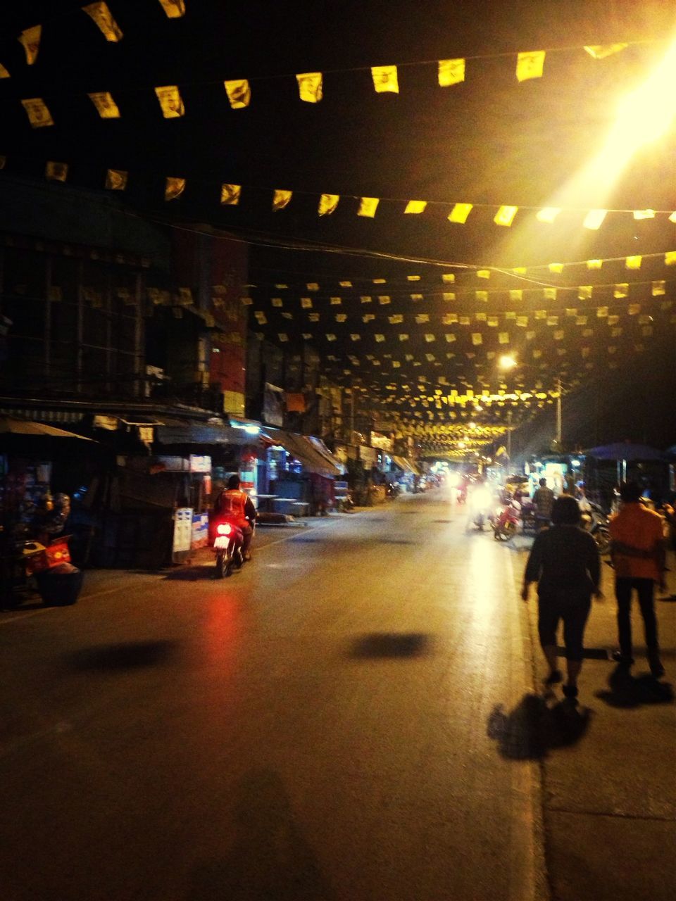 illuminated, transportation, night, mode of transport, street, land vehicle, city, city life, built structure, city street, lighting equipment, building exterior, architecture, car, incidental people, road, on the move, street light, high angle view