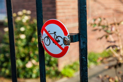 Close-up of warning sign on metal pole