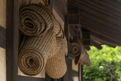 Close-up of straw mat hanging on the wall of a rural house