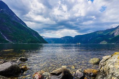 Scenic view of lake and mountains against sky