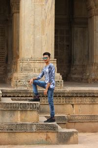 Full length of young man standing on staircase