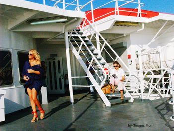 Full length of woman standing by railing