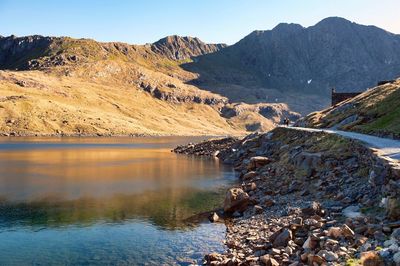 Scenic view of lake and mountains against clear sky
