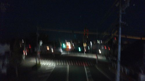 Illuminated lights on road in city at night