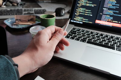 Midsection of man using laptop