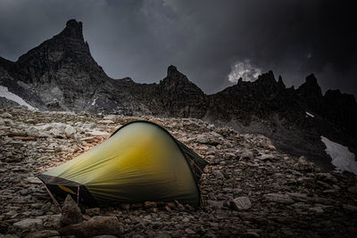 Tent on rock against sky