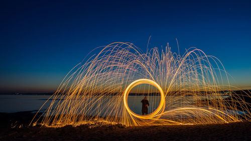 Light painting against sky at night