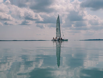 Sailboat sailing in sea against sky