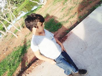 High angle view of boy sitting outdoors