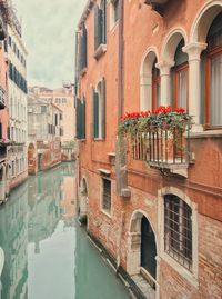 Canal amidst buildings in city