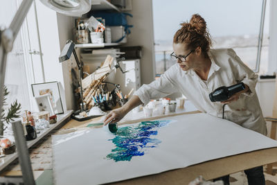 Artist painting in studio