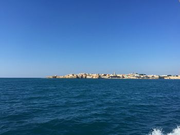 Scenic view of sea against clear blue sky