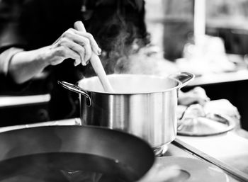 Midsection of man preparing food in kitchen