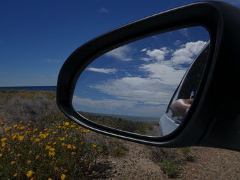 Reflection of sky on side-view mirror