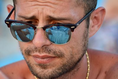 Close-up portrait of man wearing sunglasses