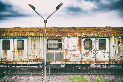 Abandoned train on railroad track against sky