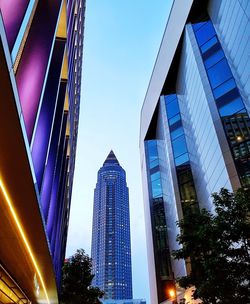 Low angle view of skyscrapers against clear blue sky