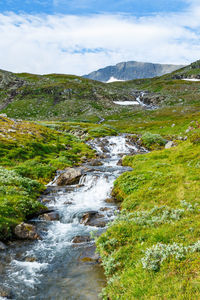 Scenic view of lake and mountains against sky