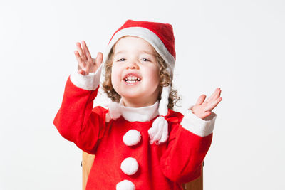 Portrait of smiling girl against white background