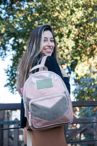 Sensual blond woman wearing backpack