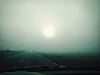 Road passing through foggy weather