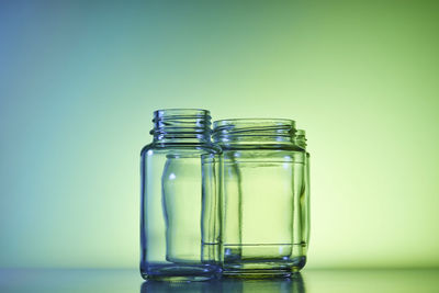 Close-up of glass jar on table against blue background