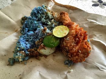 High angle view of nasi kerabu on paper