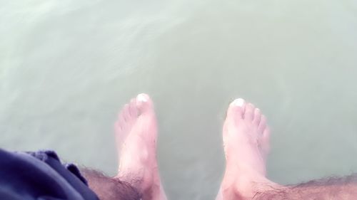 Low section of man relaxing in water