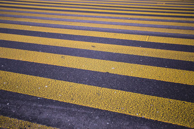 Full frame shot of zebra crossing on asphalt road