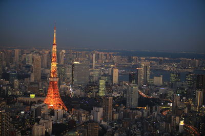 Illuminated buildings in city at night, urban skyline at tokyo with tokyo tower