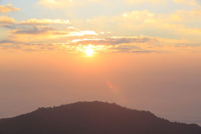 Scenic view of silhouette mountains against romantic sky at sunset