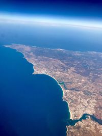 Aerial view of sea against blue sky