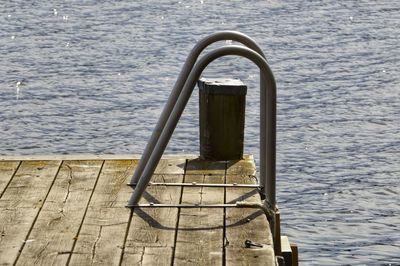 High angle view of ladder on pier by sea