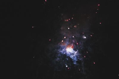 Low angle view of firework display at night