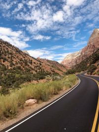 Road amidst mountains against sky