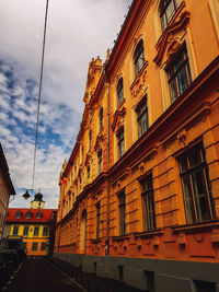 Low angle view of buildings in town against sky