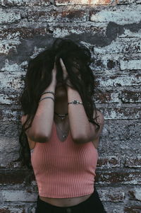 Midsection of woman standing against wall