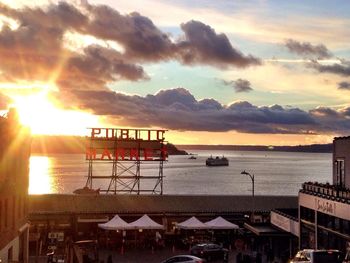 Boats in river at sunset