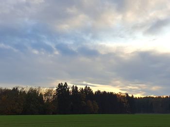 Scenic view of field against sky during sunset