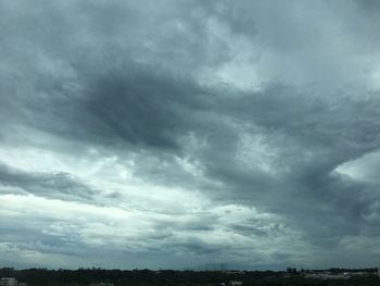 Low angle view of storm clouds over landscape