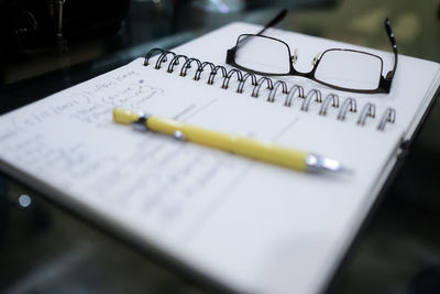 A still life image of a note book on a meeting table