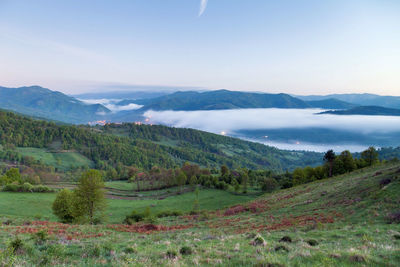 Scenic view of landscape and mountains against sky