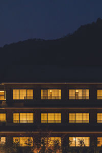 Low angle view of illuminated building against sky at night